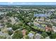 An areal view shows a waterway winding through a neighborhood with mature trees at 120 Springwood Trl, Altamonte Springs, FL 32714