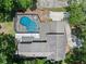 Overhead view of a home showcasing a large pool and patio, surrounded by trees and a driveway at 120 Springwood Trl, Altamonte Springs, FL 32714