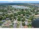 Aerial view of neighborhood with homes, mature trees, and a scenic lake nearby at 120 Springwood Trl, Altamonte Springs, FL 32714