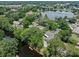 Aerial view showcases the home's large lot, mature trees, and lake access at 120 Springwood Trl, Altamonte Springs, FL 32714