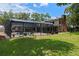 Backyard view with a screened pool, patio furniture, and the home's exterior at 120 Springwood Trl, Altamonte Springs, FL 32714