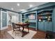Finished basement with wooden desk, custom teal shelving and cabinets at 120 Springwood Trl, Altamonte Springs, FL 32714