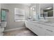 Bathroom featuring double sinks, modern cabinets, marble countertop, square bowl sinks and large vanity mirror at 120 Springwood Trl, Altamonte Springs, FL 32714