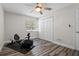 Bright bedroom featuring modern wood-look floors, a ceiling fan, a window, and a double-door closet at 120 Springwood Trl, Altamonte Springs, FL 32714