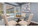 Bright breakfast nook with a glass-top table, comfortable seating, and views of the sparkling pool at 120 Springwood Trl, Altamonte Springs, FL 32714