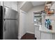 Convenient butler's pantry with stainless steel refrigerator, sleek countertop, and stylish shelving at 120 Springwood Trl, Altamonte Springs, FL 32714