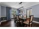 Elegant dining room with a dark wood table, stylish chairs, and large windows with natural light at 120 Springwood Trl, Altamonte Springs, FL 32714
