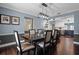 Dining room with an open view of kitchen and dark wood table and chair set at 120 Springwood Trl, Altamonte Springs, FL 32714