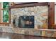Rustic stone fireplace with metal grate and adjacent decor at 120 Springwood Trl, Altamonte Springs, FL 32714