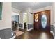 Inviting foyer features hardwood floors, a stained-glass front door, and views to the dining room at 120 Springwood Trl, Altamonte Springs, FL 32714
