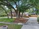 Large home with mature trees, a circular driveway, and meticulous landscaping at 120 Springwood Trl, Altamonte Springs, FL 32714
