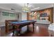 Spacious game room features a pool table, foosball table, fireplace, and rich hardwood floors at 120 Springwood Trl, Altamonte Springs, FL 32714