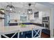 Modern kitchen features white cabinets, blue accents, an island with seating, and stainless steel appliances at 120 Springwood Trl, Altamonte Springs, FL 32714