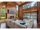 Cozy living room with stone fireplace, wood paneling, and view of the pool at 120 Springwood Trl, Altamonte Springs, FL 32714
