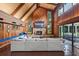 Open floor plan features a fireplace, soaring wood-clad ceilings, and a wall of windows overlooking the backyard at 120 Springwood Trl, Altamonte Springs, FL 32714