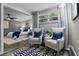 Relaxing sitting area featuring two chairs and view into bedroom with soft, neutral colors and modern fixtures at 120 Springwood Trl, Altamonte Springs, FL 32714