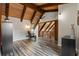 Open floor plan with wood ceilings, wood beams, a gray chair and wood-look floors at 120 Springwood Trl, Altamonte Springs, FL 32714