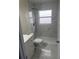 This bathroom features modern tiles, shower, and white cabinets at 1241 Cleveland Ave, Apopka, FL 32703