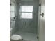 This bathroom features modern shower and white tiles at 1241 Cleveland Ave, Apopka, FL 32703