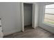 Bedroom featuring laminate flooring, a window, and a closet with bi-fold doors at 1241 Cleveland Ave, Apopka, FL 32703