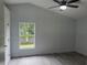 This bedroom features wood floors, ceiling fan, and a window view at 1241 Cleveland Ave, Apopka, FL 32703