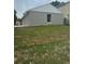 Rear exterior of home with newer windows, painted block, and an expansive lawn at 1241 Cleveland Ave, Apopka, FL 32703