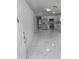 Bright, updated kitchen featuring stainless steel appliances, white cabinets, and elegant marble-look flooring at 1241 Cleveland Ave, Apopka, FL 32703