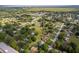Aerial view of a home surrounded by lush greenery in a serene neighborhood at 1242 Liza St, St Cloud, FL 34771