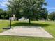 Grassy backyard with a basketball court, perfect for outdoor activities and Gathering fun at 1242 Liza St, St Cloud, FL 34771