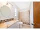 Bathroom featuring decorative sink with stone accent, tiled shower, and neutral wall color at 1242 Liza St, St Cloud, FL 34771