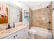 Well-lit bathroom with a shower-tub combo and white vanity with sink at 1242 Liza St, St Cloud, FL 34771