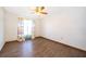 Bright bedroom with hardwood floors, floral curtains, and a ceiling fan at 1242 Liza St, St Cloud, FL 34771