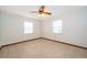 Bright bedroom with tile flooring, ceiling fan, and two windows at 1242 Liza St, St Cloud, FL 34771