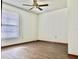 This bedroom features wood-look flooring, a window, and a ceiling fan at 1242 Liza St, St Cloud, FL 34771