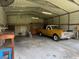 Spacious garage featuring work bench, overhead lighting, and space for vehicle parking at 1242 Liza St, St Cloud, FL 34771