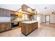 Kitchen with stainless steel appliances, island, and wood cabinets at 1242 Liza St, St Cloud, FL 34771