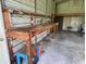 Spacious workshop featuring a sturdy wooden workbench, perfect for hobbies or DIY projects at 1242 Liza St, St Cloud, FL 34771