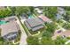 Expansive aerial view of a home with well-maintained landscaping and a swimming pool, in a lush neighborhood at 1355 Hibiscus Ave, Winter Park, FL 32789