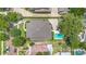Aerial view of the property showcasing the roof, swimming pool, driveway, and surrounding greenery at 1355 Hibiscus Ave, Winter Park, FL 32789