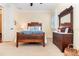Cozy bedroom with a wood-frame bed, a dresser, and a view to the outside at 1355 Hibiscus Ave, Winter Park, FL 32789
