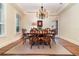 Formal dining room with hardwood floors, a chandelier, and a wooden table with chairs at 1355 Hibiscus Ave, Winter Park, FL 32789