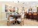 Dining room showcases a round table and chairs beside a kitchen with counter seating at 1355 Hibiscus Ave, Winter Park, FL 32789