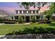 Charming two-story home with a manicured lawn and landscaped garden beds at 1355 Hibiscus Ave, Winter Park, FL 32789