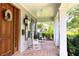 Inviting front porch with rocking chairs and a wood door with sidelights at 1355 Hibiscus Ave, Winter Park, FL 32789