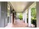 Charming front porch featuring classic brick flooring, rocking chairs, and stately columns at 1355 Hibiscus Ave, Winter Park, FL 32789