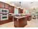 Gourmet kitchen with stainless steel appliances, granite countertops, and custom cabinetry at 1355 Hibiscus Ave, Winter Park, FL 32789