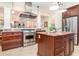Stylish kitchen with stainless steel appliances, a center island, and tile floors at 1355 Hibiscus Ave, Winter Park, FL 32789