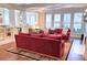 Open living room with hardwood floors, white trim, and access to other rooms at 1355 Hibiscus Ave, Winter Park, FL 32789