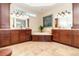 A spacious main bathroom featuring double vanities, a soaking tub, and tile flooring at 1355 Hibiscus Ave, Winter Park, FL 32789