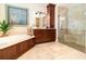 Main bathroom features a soaking tub, a walk-in shower, and tile flooring at 1355 Hibiscus Ave, Winter Park, FL 32789